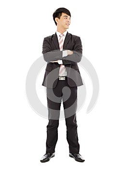 Smiling businessman standing and crossed arms over white