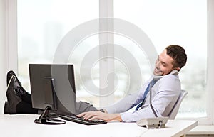 Smiling businessman or student with computer