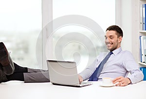 Smiling businessman or student with laptop