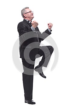 Smiling businessman in suit holding keys with thumb up