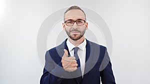 Smiling businessman in suit posing showing thumb up. Medium close up shot on 4k RED camera