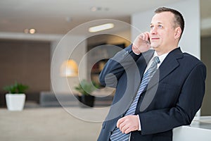 Smiling businessman talking on the phone photo