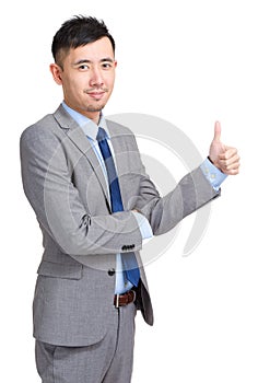 Smiling businessman with thumb up