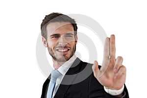 Smiling businessman touching invisible interface