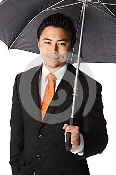 Smiling businessman with umbrella