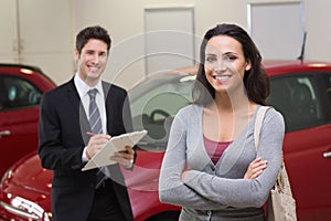 Smiling businessman undersign a car contract