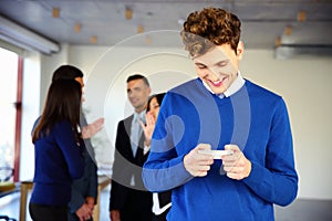 Smiling businessman using smartphone