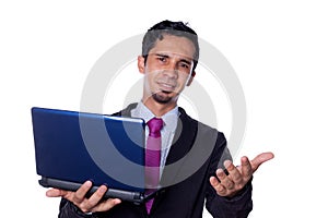 Smiling businessman waves and holds laptop in his hand. Latin man using technology, isolated on all white background