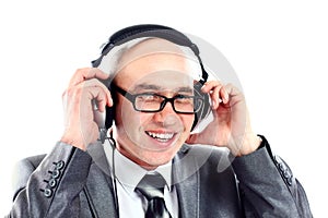 Smiling businessman wearing headphones looking to camera