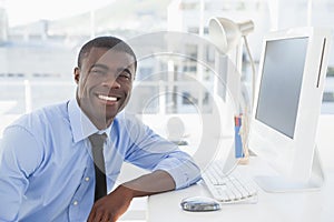 Smiling businessman working at his desk