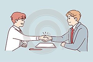 Smiling businessmen handshake closing deal