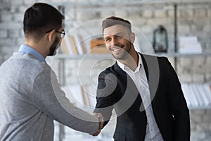 Smiling businessmen handshake get acquainted at meeting