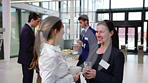 Smiling businesspeople interacting with each other during break