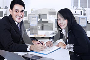 Smiling businesspeople after signing business contract