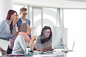 Smiling businesspeople working together at conference table