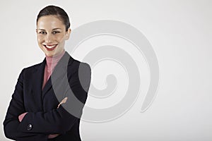 Smiling Businesswoman With Arms Crossed