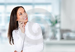 Smiling businesswoman in formalwear sitting at workplace