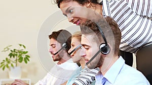 Smiling businesswoman helping call center agent