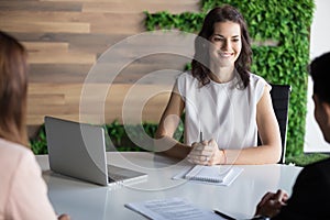 Smiling businesswoman hold business meeting with partners