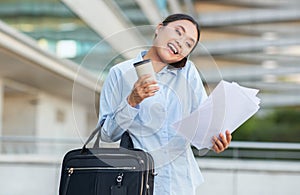 Smiling Businesswoman Holding Coffee and Papers While Walking Outside Office