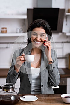 Smiling businesswoman holding cup of coffee