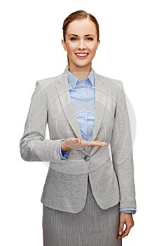 Smiling businesswoman holding something imaginary