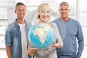 Smiling businesswoman holding terrestrial globe