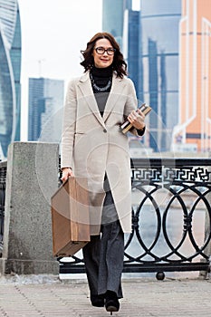 Smiling businesswoman in a light coat