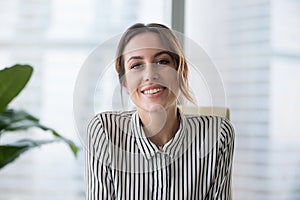 Smiling businesswoman looking at camera webcam make conference business call photo