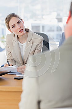 Smiling businesswoman looking at interviewee photo