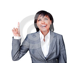 Smiling businesswoman pointing upwards