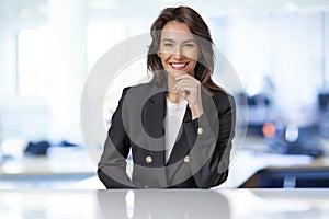 Smiling businesswoman portrait while sitting at the office