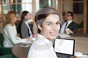 Smiling businesswoman professional interpreter looking at camera photo