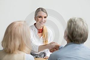 Smiling businesswoman shaking hand of senior hr at job interview