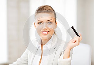 Smiling businesswoman showing credit card