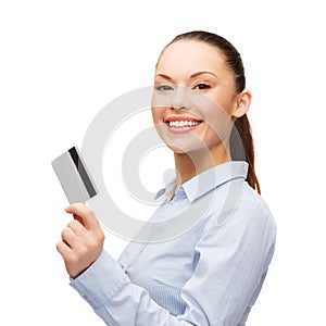 Smiling businesswoman showing credit card