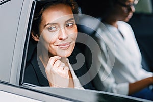 Smiling businesswoman sitting in a cab