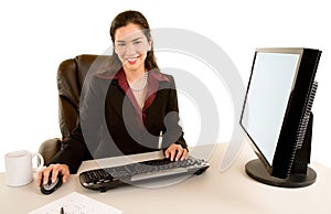 Smiling Businesswoman Sitting at her Desk