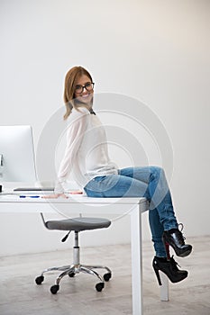 Smiling businesswoman sitting on the table