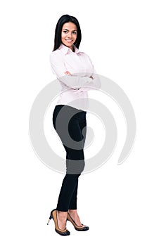 Smiling businesswoman standing with arms folded