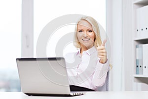 Smiling businesswoman or student with laptop