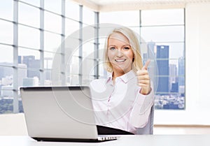 Smiling businesswoman or student with laptop