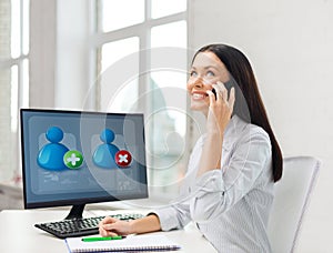 Smiling businesswoman or student with smartphone