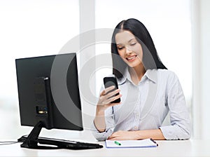 Smiling businesswoman or student with smartphone