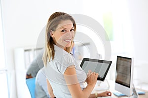 Smiling businesswoman with tablet