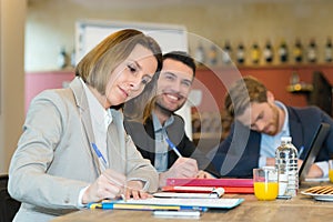 Smiling businesswoman talking with partner at busisness lunch