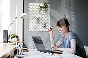 Smiling businesswoman talking to client via videoconferencing