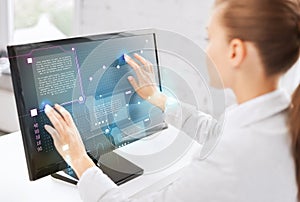 Smiling businesswoman with touchscreen in office