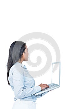 Smiling businesswoman using her laptop