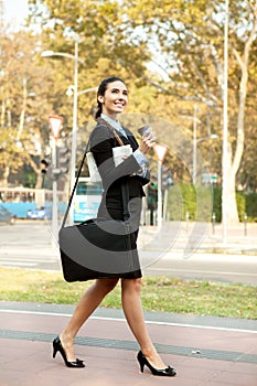 Smiling businesswoman walking